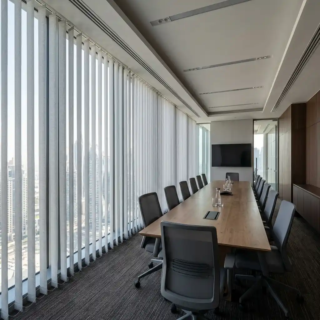 White motorized vertical blinds in a Dubai office conference room